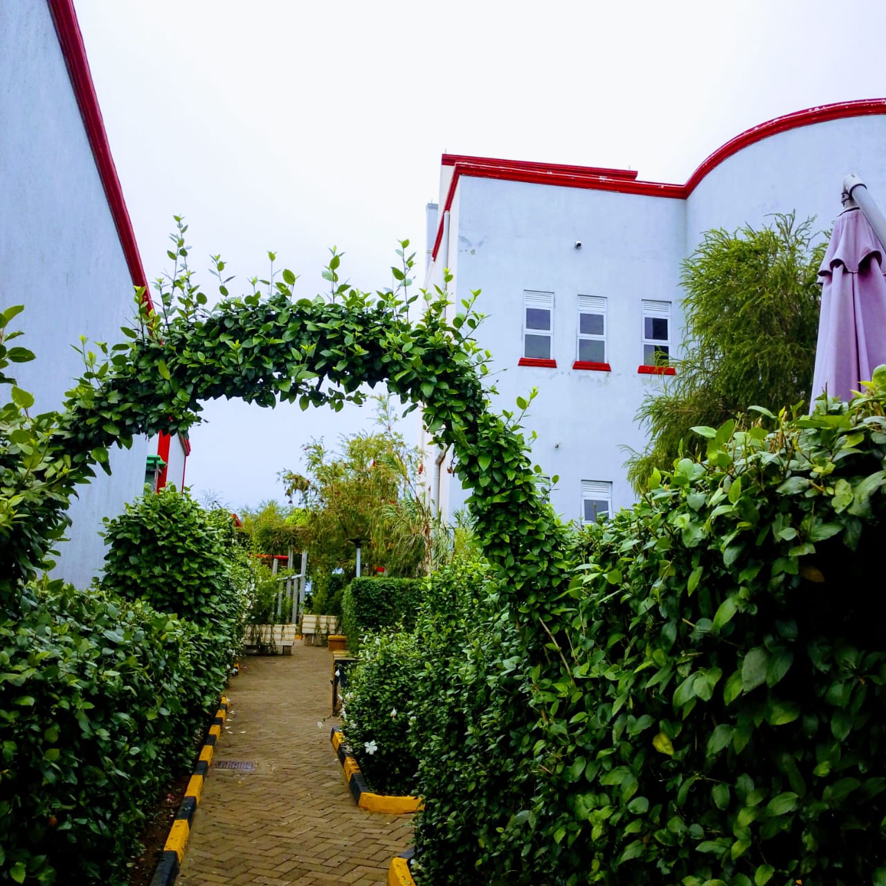 Akengyeya Country Hotel garden entrance with decorative arch, Mbarara Uganda